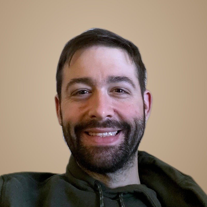 Byron Clarke, smiling, in a green hoodie
